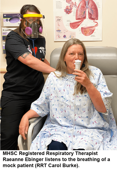 MHSC Registered Respiratory Therapist Raeanne Ebinger listens to the breathing of a mock patient (RRT Carol Burke).